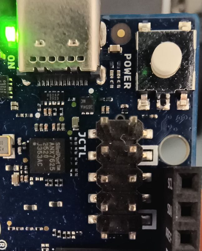 Close-up of the Arduino UNO Q next to the USB-C connector: the 2x5 JCTL header, with the two ground pins marked by a white square in the silkscreen